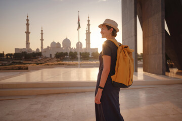 travel to the United Arab Emirates, Happy young asian female traveler with backpack and hat in...