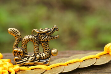 Dragon figurine with Chinese coins. A religious symbol.