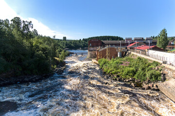 Fototapeta na wymiar lyaskelsky waterfall is the largest waterfall on the Yanisjoki River, which now serves as a spillway of the hydroelectric dam. Lyaskelya settlement, Karelia, Russia