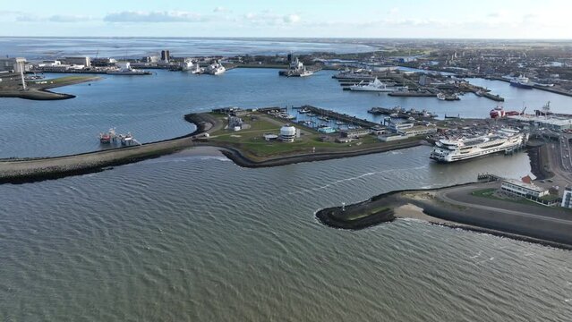 A stunning drone view of the Den Helder harbor, a bustling hub for maritime activities, from offshore oil rigs to the royal Dutch navy and Texel ferries.