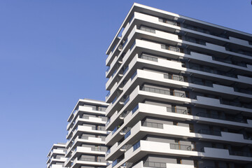 Facades of large residential buildings against the blue sky.