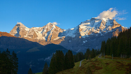 Fototapeta premium Mountain view of Jungfrau, Monch, Eiger peaks at sunset in Switzerland Bernese region.