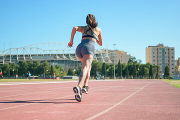 Obraz premium Fitness runner woman on running track working out