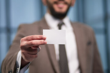 Close up of businessman hand showing business card