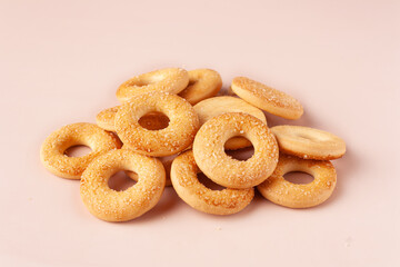 mini cookies in the shape of rings with sugar on a beige background