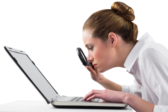 Businesswoman typing and looking through magnifying glass - Powered by Adobe