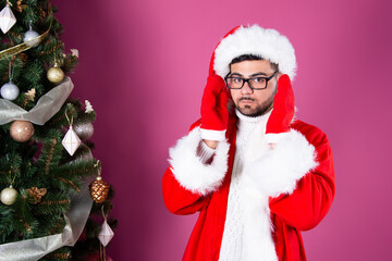 Young attractive student on a holiday dressed as Santa Claus