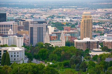 Fototapeta premium Salt Lake Utah Temple, the church of Jesus Christ of Latter Day Saints at sunrise with Salt Lake City modern skyline at the background, Salt Lake City, Utah UT, USA. 