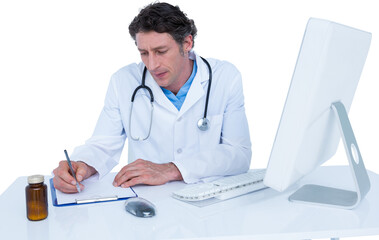Doctor writing on paper while sitting at desk
