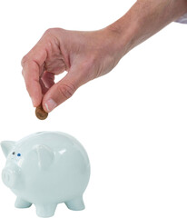 Cropped hand of person inserting coin in piggy bank