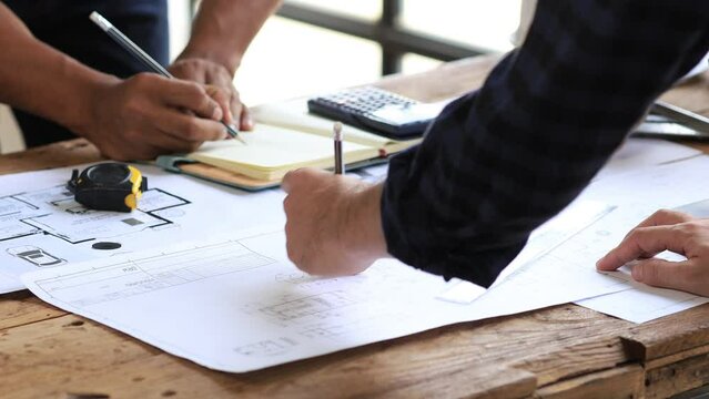 Architects and engineers are working together to edit the draft house plan that was designed after it was presented to the client and partially revised the design. Interior design and decoration ideas