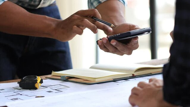 Architects and engineers are working together to edit the draft house plan that was designed after it was presented to the client and partially revised the design. Interior design and decoration ideas