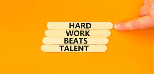 Hard work beats talent symbol. Concept words Hard work beats talent on wooden stick. Beautiful orange table orange background. Motivational business hard work beats talent concept. Copy space.