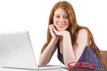 Pretty redhead working on laptop