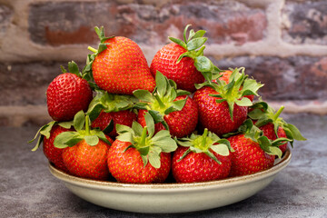 Fresh strawberries from the garden on the plate.