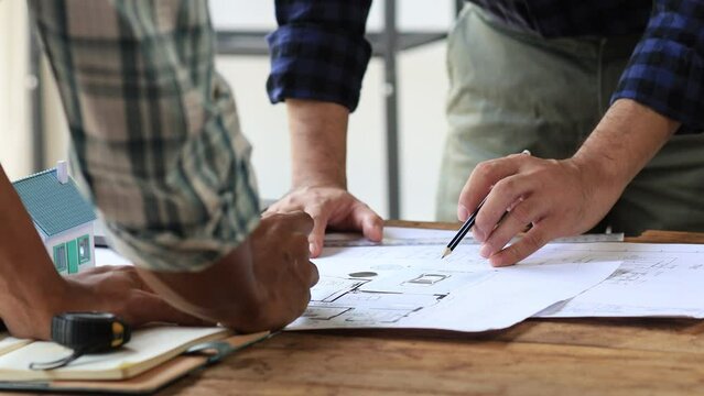 Architects and engineers are working together to edit the draft house plan that was designed after it was presented to the client and partially revised the design. Interior design and decoration ideas