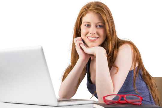 Pretty redhead working on laptop