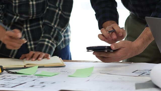 Architects and engineers are working together to edit the draft house plan that was designed after it was presented to the client and partially revised the design. Interior design and decoration ideas