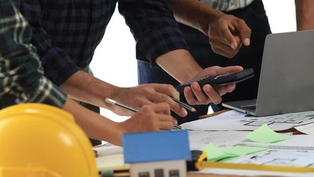 Architects and engineers are working together to edit the draft house plan that was designed after it was presented to the client and partially revised the design. Interior design and decoration ideas