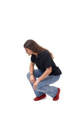 side view of a young girl crouching and searching at the ground on white background