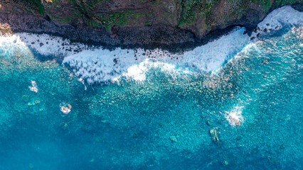 Drone image of the coast and blue water at Miradouro do Bom Jesus on Madeira in Portugal