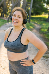 Fat body positivity woman and sports. Girl doing exercise for weight loss in the fresh air and laughing in camera after training