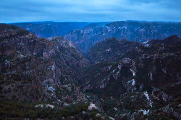 blue hour in canyon with cloudy sky, blue mountains, copper canyon in sierra tarahumara, chihuahua