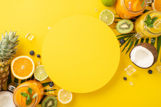 Add some zest to your marketing with trendy flat lay photo of fresh orange, lemon, lime, and grapefruit juice in glass jars, arranged on a sunny yellow background with an empty circle for your text