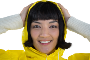 Woman wearing yellow raincoat against white background