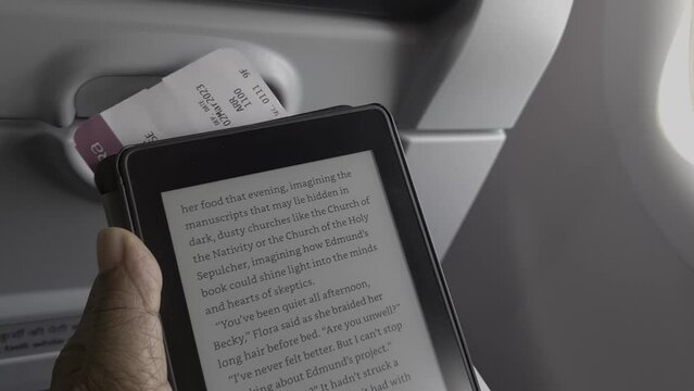Reading book from an e book reader on board while the plane waited for take off