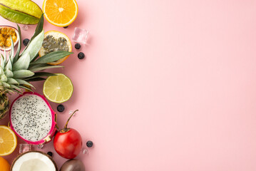 Refreshing summer concept. Top flat lay view photo of exotic fruit juice, dragon-fruit, kiwi, pineapple, orange, lime, coconut on pastel pink background with empty space for text