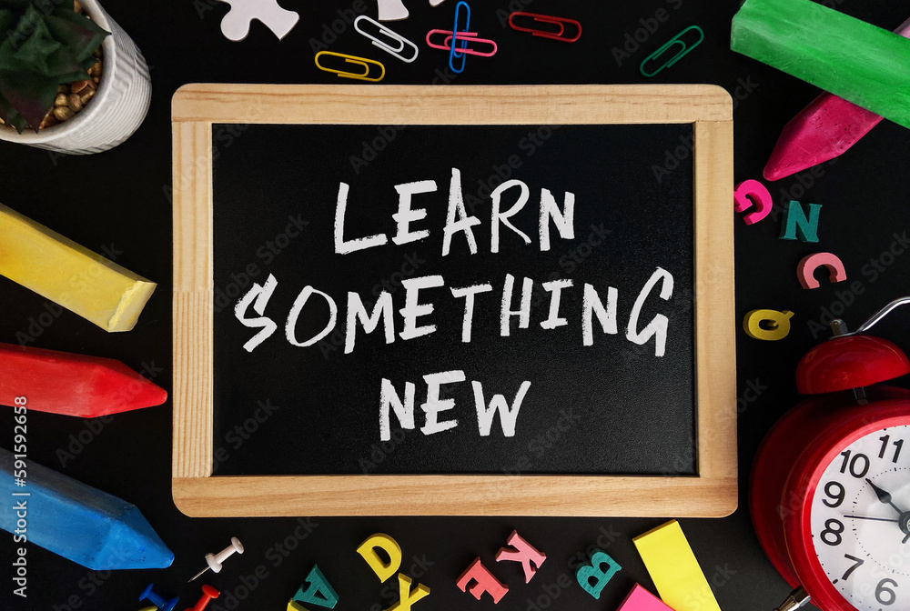 Aufkleber wooden board with learn something new text on a background of various colorful subjects