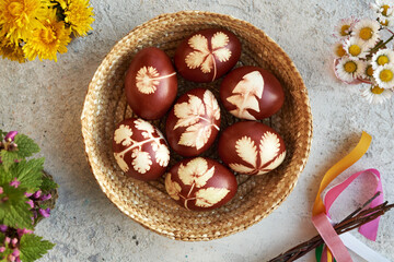 Easter eggs dyed with onion skins with a pattern of herbs, top view