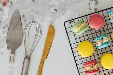 traditional french colorful macarons in a rows on a metal mesh