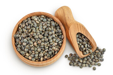 raw french green lentils in wooden bowl isolated on white background. Top view. Flat lay