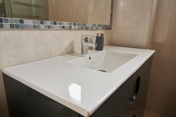Close-up of a silver bathroom faucet and soap dispenser