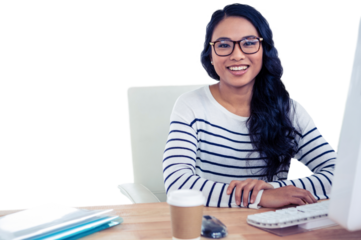 Smiling Asian woman sitting at desk posing for camera