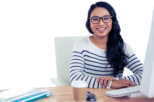 Smiling Asian woman sitting at desk posing for camera