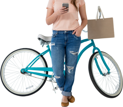 Low section of woman using mobile phone while leaning on bicycle