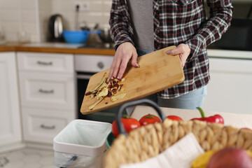 Woman throwing food peels in a domestic compost bin. Female person recycling organic food waste in a bokashi container with ferment