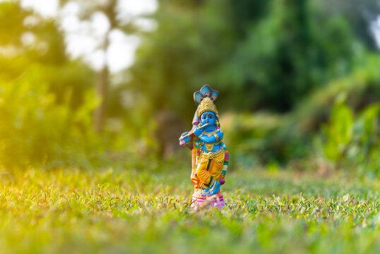 Lord Krishna sculpture on a park with copy space, Kerala Vishu festival background