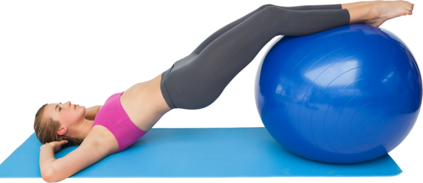 Side view of a fit woman exercising with fitness ball
