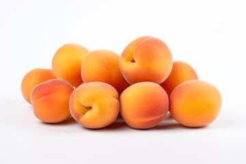 A pile of apricots on a white background
