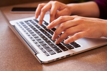 Close-up of the hands of businesswoman typing with a laptop