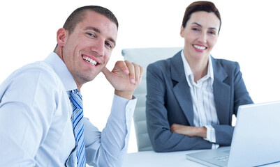 Portrait of smiling business people sitting at desk