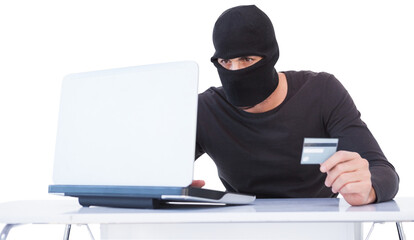 Burglar doing online shopping with laptop and credit card