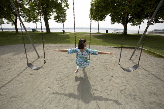 Woman Sitting on Swing