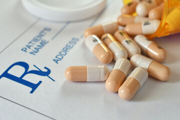 Pills medicine pharmaceutical drugs laying on a prescription RX pad © MargJohnsonVA