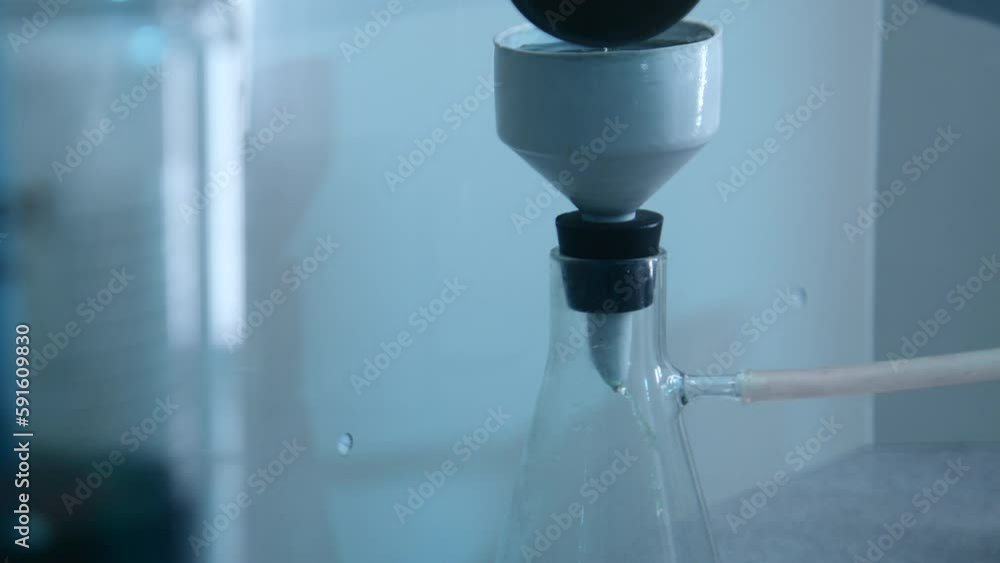 Poster chemist pours liquid into flask. stock footage. chemist conducts experiment with flask and liquid su