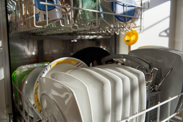 Side view of dishes and utensils in a dishwasher